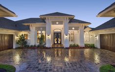 a large house with two garages on the front and one entrance to the back