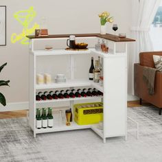 a white wine rack with bottles and glasses on it next to a couch in a living room