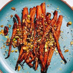 carrots with nuts and sesame seeds on a blue plate