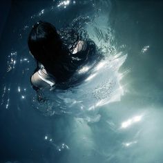 a woman is swimming in the water