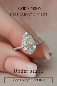 a woman's hand holding an engagement ring with the words under $ 1, 200