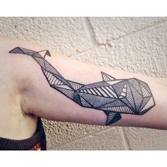 a man's arm with an origami style tattoo on it, and the image of a paper airplane