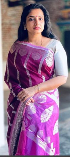 a woman in a purple and white sari