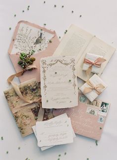 the wedding stationery is laid out on top of each other, including an open book