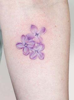 a small purple flower tattoo on the right thigh