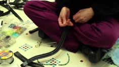 a person sitting on the floor with many items around them