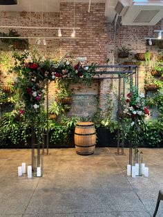 an indoor wedding venue with flowers and greenery