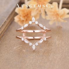 a rose gold ring with three pear shaped diamonds