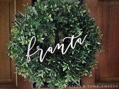 a green wreath with the word branta written in cursive writing on it