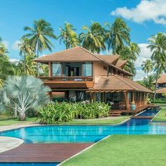 an outdoor swimming pool surrounded by palm trees