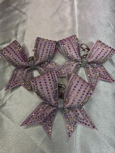 a purple and silver bow with sequins on it