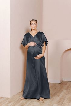 Our graceful Gwen Satin dress has been modified with a higher waistline and extra room to accommodate a growing bump, becoming the perfect option for the mommy-to-be in your bridal party! While a little more modest in coverage, the Gwen still features flutter sleeves and a delicate front twist detail that adds sophistication to a timeless design. FEATURES: Empire silhouette V-neckline Built-in bra cups and vertical boning for support Dolman flutter sleeves Back zipper Full-length double lining f Elegant Maternity Dress Nursing Friendly, Elegant Nursing-friendly Maternity Dress, Elegant Short Sleeve Maternity Dress Bump Friendly, Elegant V-neck Maternity Gown, Elegant Maternity Maxi Dress With Short Sleeves, Elegant Short Sleeve Maternity Maxi Dress, Elegant Nursing Friendly V-neck Dress, Elegant V-neck Maternity Dress Nursing Friendly, Elegant V-neck Bump-friendly Dress