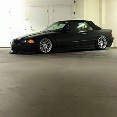 a black car parked in a parking garage