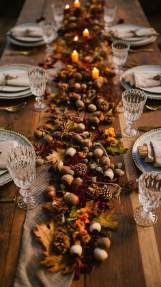 the table is set with candles, plates and napkins for an elegant thanksgiving dinner