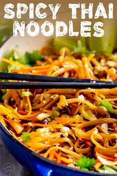 a blue bowl filled with noodles and vegetables