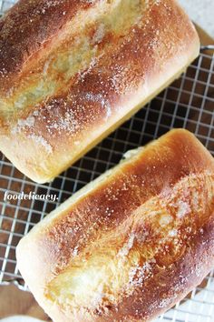 two loaves of bread sitting on top of a cooling rack