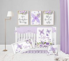 a baby's room with purple and white decor