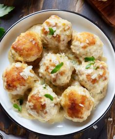 a white plate topped with meatballs covered in cheese