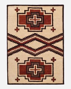 an area rug with geometric designs and crosses on the center, in red, brown, beige and black colors