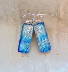 "The stones in these beautiful earrings measure approximately 1\" by 3/8\".  They are hung with sterling silver French wire hooks and hang approximately 1 3/8\".  The dichroic glass in these earrings shimmer with silver and blue on black colored glass.  They are capped with clear and full fused for strength and depth. Thank you for looking in my shop.  All of my pendants and earrings will arrive in a gift box.  I do my best to accurately photograph my work so you will be happy with your purchase. Dichroic Glass changes colors with different lighting and different angles, therefore making it difficult to photograph. You must see my dichroic pieces in hand to appreciate the color and depth of each piece. They are so much more beautiful in person, than in the photographsyou must see to apprec Sterling Silver Blue French Hook Earrings, Blue Sterling Silver Earrings With French Hook, Nickel Free Long Drop Earrings Gift, Gift Dangle Linear Earrings With Lever Back, Gift Linear Dangle Earrings With Lever Back, Rectangular Blue Earrings For Anniversary, Silver Linear Earrings With French Hook Gift, Blue Nickel-free Linear Earrings For Gift, Sterling Silver French Hook Drop Earrings