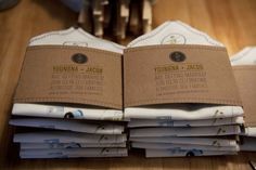 several stacks of papers sitting on top of a wooden table next to a pair of scissors