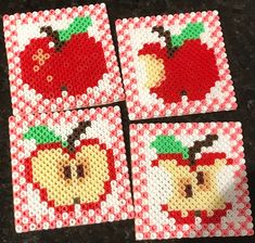 four red and white coasters with apples on them