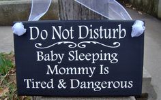 a sign that says, do not disturb baby sleeping mommy is tired and dangerously dangerous