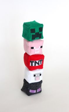 a stack of knitted toys sitting on top of each other in front of a white background