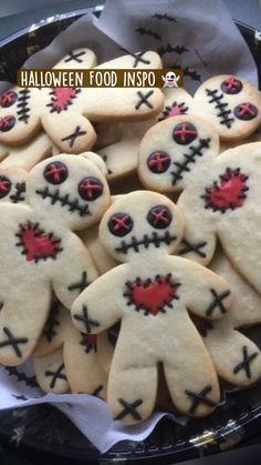 decorated cookies in the shape of zombies on a plate