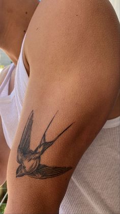 a woman with a bird tattoo on her arm