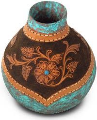 a brown and blue vase with flowers painted on it