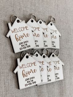 six house shaped key chains with welcome home tags