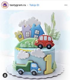 a birthday cake with cars and houses on it