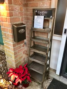 a wooden shelf sitting in front of a brick wall next to a red poinsettia