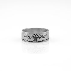 a silver ring with a tree on it