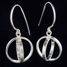 Handmade sterling silver orb dangles were created by making a small circle fit inside of a larger one. Orbs are lightweight and move gracefully on your ear.Size of earring:depth = 0.80 incheswidth = 0.80 inchesheight = 1.45 inches (including ear wire) Hypoallergenic Open Circle Jewelry For Anniversary, Hypoallergenic Open Circle Anniversary Jewelry, Minimalist Pierced Open Circle Jewelry, Sterling Silver Circle Jewelry, Sterling Silver Open Circle Formal Jewelry, Sterling Silver Open Circle Jewelry For Formal Occasions, Minimalist White Gold Linear Earrings, Modern Round Hypoallergenic Jewelry, Modern Hypoallergenic Round Jewelry