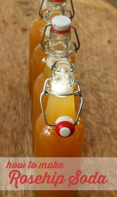 three bottles filled with liquid sitting on top of a wooden table