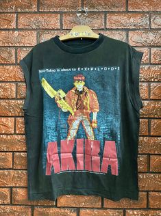 Distressed Akira Japanese Cyber Punk Anime 1988 Movie Poster Sleeveless T Shirt / Japanese Cyberpunk Anime / Pop Culture T Shirt Size L Condition : Heavy Used Size on tag : L (Resized) Colour : Black Brand : Unknown Measurement : Armpit to armpit - 22" Length - 27" Material : Cotton Made In: Unknown THE SHIPPING (Your Choice Please read) 1. The shipping cost is USD 20 via Malaysian Registered Postage With Tracking Number. It will take 2-4 weeks or more for delivery, depends on your custom checki Grunge Graphic Print Vest For Streetwear, Punk Tank Top For Cosplay, Punk Sleeveless Cosplay Tops, Punk Style Sleeveless Tank Top For Cosplay, Punk Style Sleeveless Tops For Cosplay, Punk Sleeveless Tops For Cosplay, Alternative Sleeveless Cosplay Tops, Japanese Cyberpunk, Punk Anime