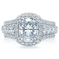 a diamond engagement ring with two rows of diamonds on the band and an oval center stone surrounded