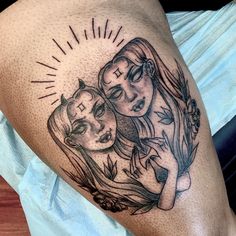 a woman's thigh with two faces on it