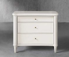 a white nightstand with two drawers on it's sides and one drawer open to the side