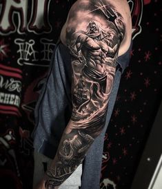 a man with a full sleeve tattoo on his arm