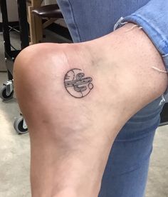 a woman's foot with a small tattoo on the side of her left leg