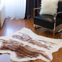 a living room with a chair and rug on the floor