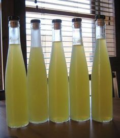 six bottles of lemonade sit on a table