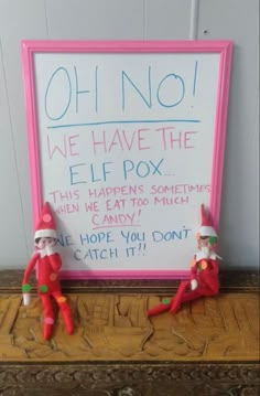 two elfs sitting in front of a sign that says oh no we have the elf pox