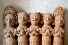 several clay figures are lined up in a row