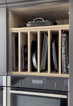 a kitchen cabinet filled with black and white dishes