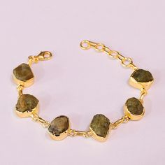 Natural Raw Multi Tourmaline Gemstone Designer Bracelet, Wholesale Brass Jewellery, Unique Gift For Her Product Details Item Code: BJBC-2322 Stone Name: Multi Tourmaline Stone Size: Fancy Metal: 18K Yellow Gold Plated Over Brass Bracelet diameter : 7.50" Inch - Adjustable Note :- This bracelets you will receive may vary slightly in color from the images because these are natural gemstones and vary to each other every single time and it is not possible to get the same color what is showing in the images. Images are for reference to get an idea of the similar color you will get. Shipping Info: All my items are safely and nicely packaged and shipped in a beautiful plastic box with bubbles wrap. The package is sent via international registered air mail that takes 12-20 working days to arrive. Gold Multi-stone Bracelets For Gifts, Gold Tourmaline Gemstone Bracelets, Classic Gold Multi-stone Bracelets, Adjustable Gold Multi-stone Bracelet, Yellow Gold Tourmaline Multi-stone Jewelry, Brass Jewellery, Designer Bracelet, Jewellery Unique, Bracelets Design