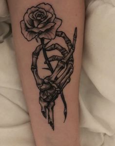 a black and white tattoo with a rose on it